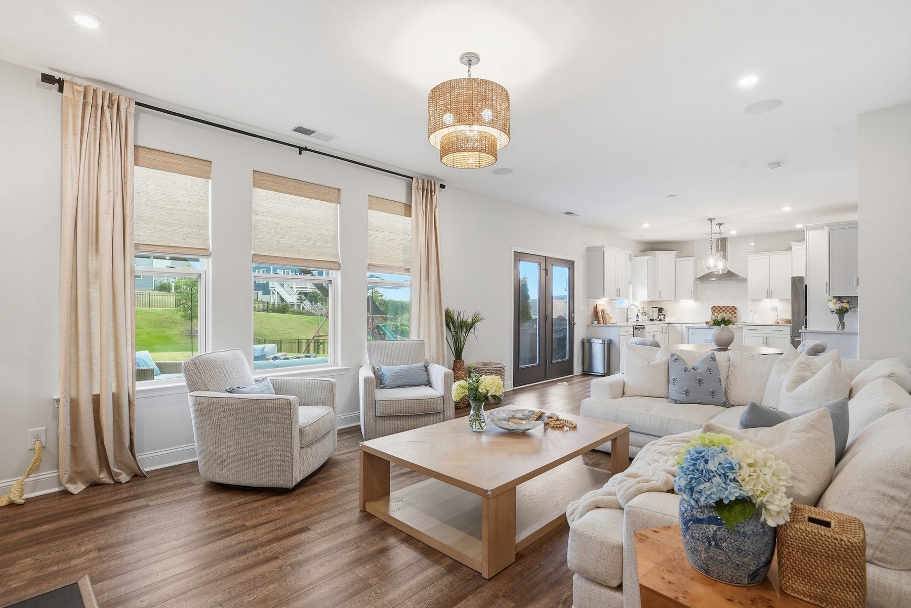 Living room with a wall of windows overlooking the back yard