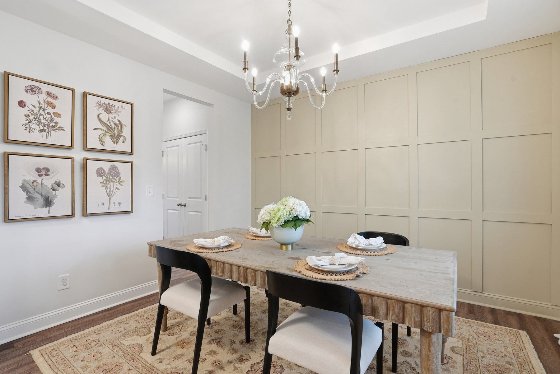 Dining room with a tray ceiling, designer accent wall and a live-edge table