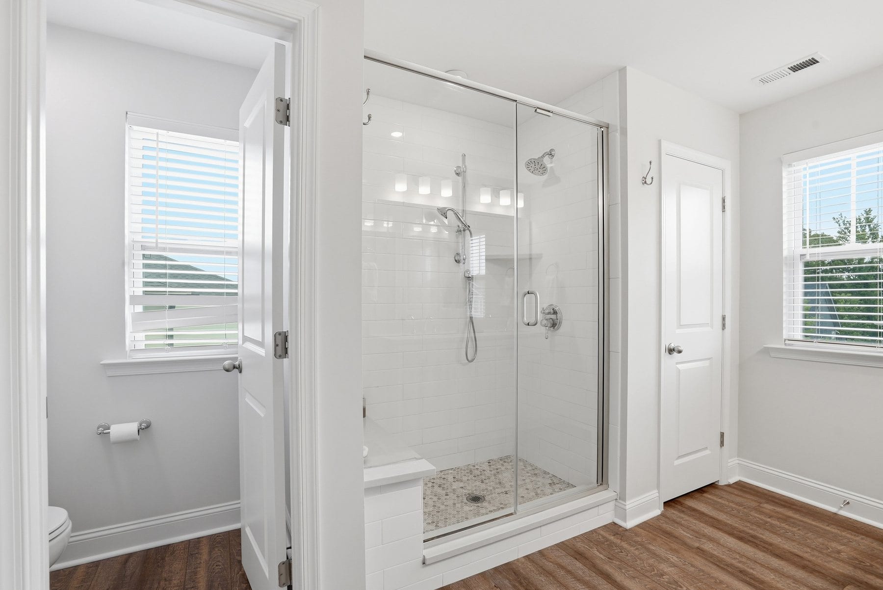 Powder bath with a green vanity, framed art and a round mirror