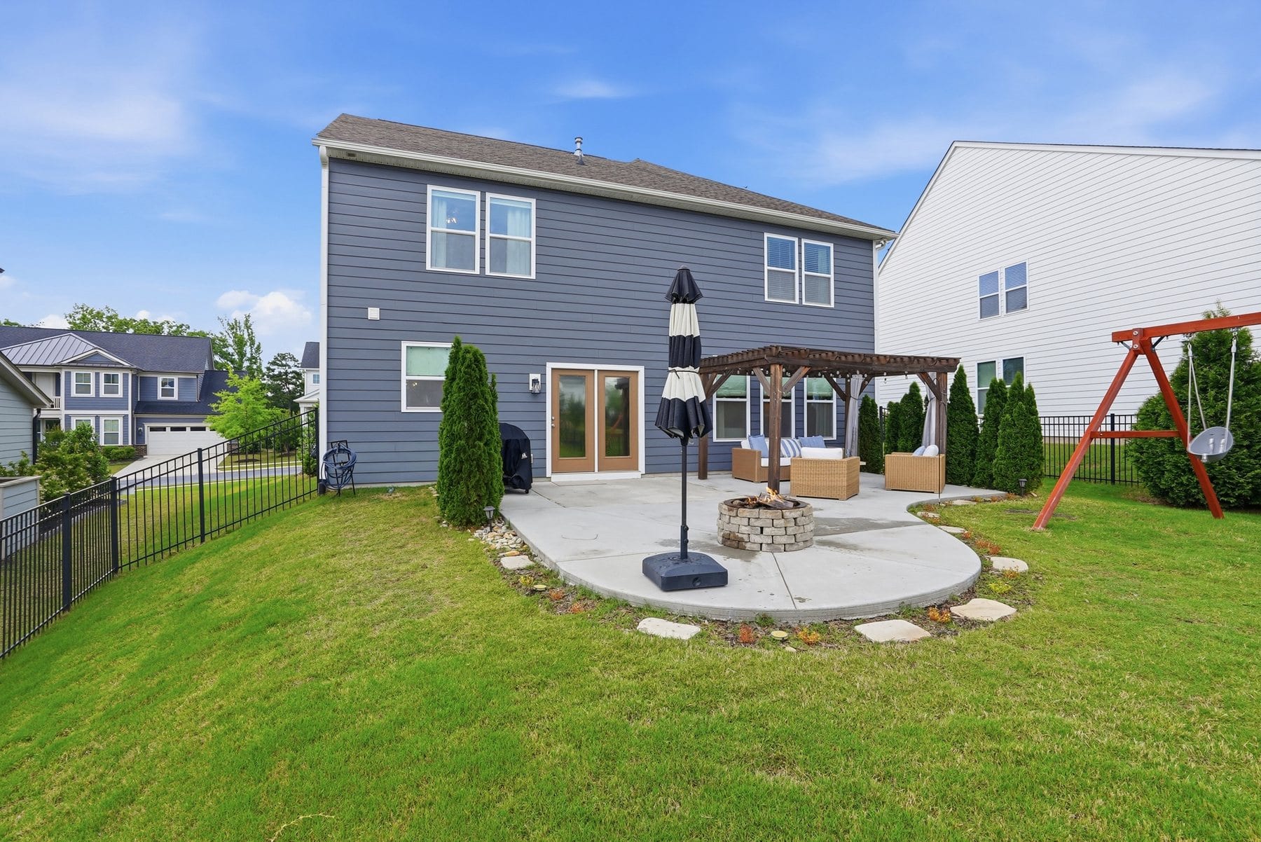 Fenced back yard with an open lawn